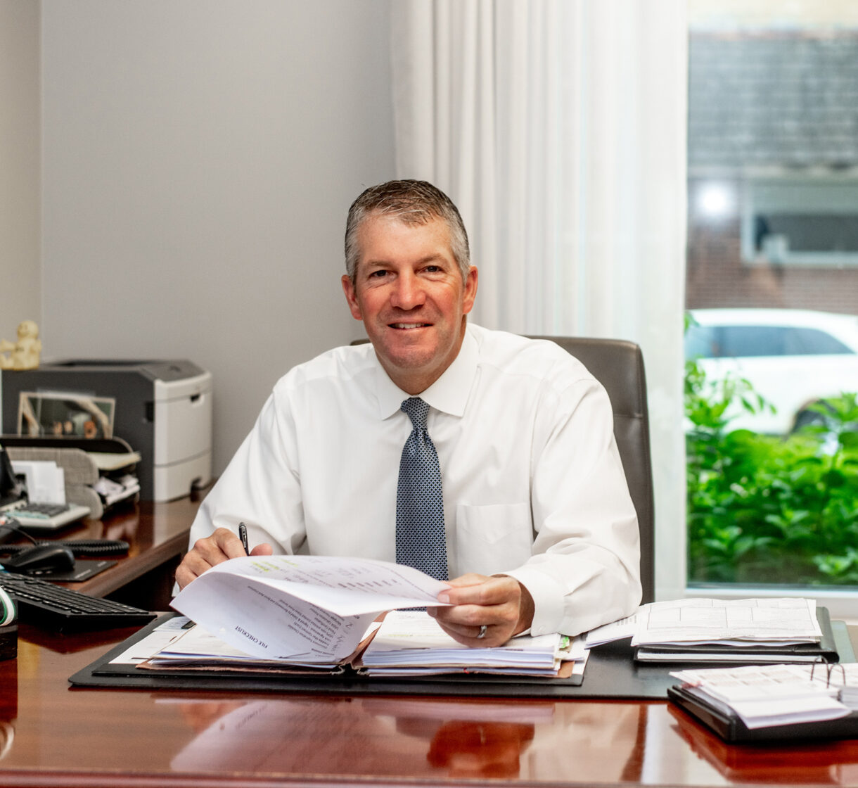 Brent Baker sitting at his desk in his office at Byron Bank ready to answer questions from customers