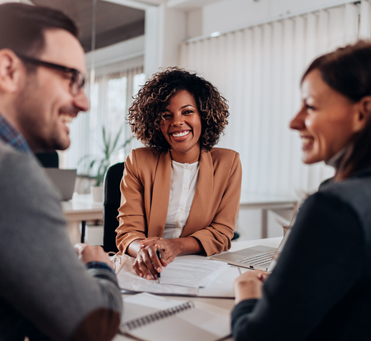 Couple consulting with a female financial manager at the bank