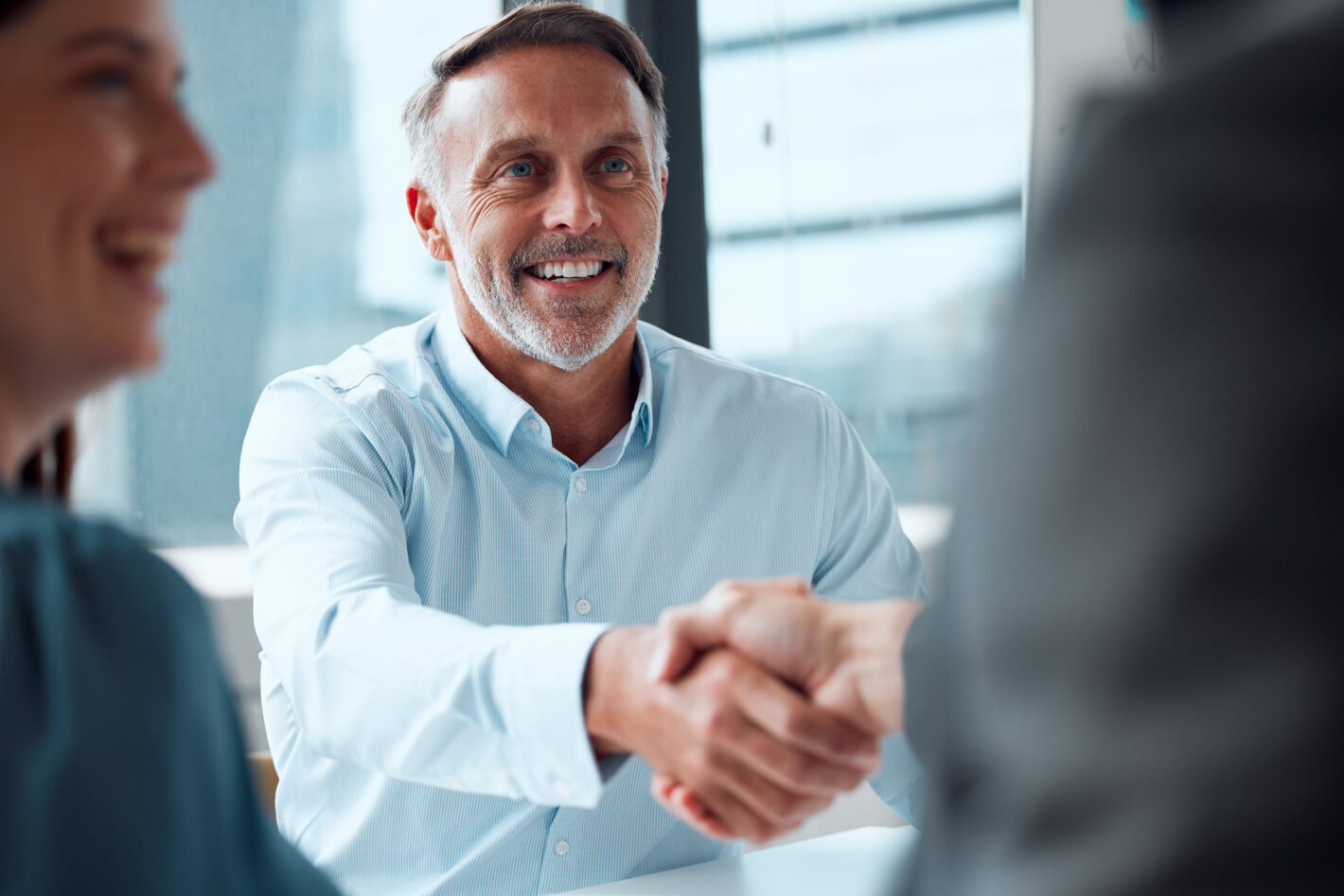 Mature businessman shaking hands with colleague